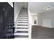 Entryway featuring staircase, wood floors and open access to the living room and kitchen at 7015 Setters Way, Lithonia, GA 30038