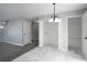 Open entryway with modern flooring, chandelier, and convenient storage spaces at 7015 Setters Way, Lithonia, GA 30038