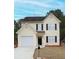 Charming two-story home with light yellow siding, black shutters, and well-maintained front yard at 7015 Setters Way, Lithonia, GA 30038