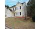 View of the two-story home's side, revealing well-kept lawn and minimal landscaping at 7015 Setters Way, Lithonia, GA 30038