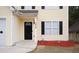 Home's entry showcasing black door, decorative door, and fresh landscaping at 7015 Setters Way, Lithonia, GA 30038