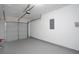 Garage with neutral walls, a garage door, and a painted floor at 7015 Setters Way, Lithonia, GA 30038