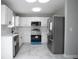 Well-lit kitchen featuring stainless steel appliances, white cabinets, and modern countertops at 7015 Setters Way, Lithonia, GA 30038