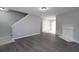 Open living room with wood floors and fireplace, leading into dining area and kitchen at 7015 Setters Way, Lithonia, GA 30038