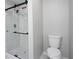 Shower featuring modern fixtures, a sliding door, and marble tile in the bathroom at 7015 Setters Way, Lithonia, GA 30038
