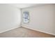 Simple bedroom with neutral carpet and window at 1569 High Falls Ln, Grayson, GA 30017