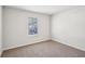 Simple bedroom with neutral wall paint and carpet at 1569 High Falls Ln, Grayson, GA 30017