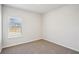 Spacious bedroom with neutral carpeting and large window at 1569 High Falls Ln, Grayson, GA 30017