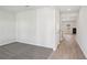 Bright foyer with gray carpet, hardwood floors, and views into the living room at 1569 High Falls Ln, Grayson, GA 30017