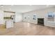 Open floor plan features a kitchen island, stainless steel appliances, and a fireplace at 1569 High Falls Ln, Grayson, GA 30017