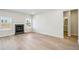 Living room with hardwood floors, fireplace, and powder room at 1569 High Falls Ln, Grayson, GA 30017