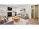 Virtually staged living room with hardwood floors, fireplace, and comfy seating at 1569 High Falls Ln, Grayson, GA 30017