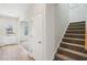 Stairway with gray carpeting leading to the second floor at 1569 High Falls Ln, Grayson, GA 30017
