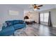 Spacious bedroom with a comfortable blue couch, modern decor, and a large window offering ample natural light at 37 Highcrest Dr, Acworth, GA 30101