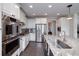 Bright, modern kitchen with stainless steel appliances, granite countertops, and white cabinetry at 37 Highcrest Dr, Acworth, GA 30101