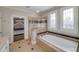 Luxurious main bathroom with soaking tub, shower, and stylish windows offer a spa-like experience at 37 Highcrest Dr, Acworth, GA 30101