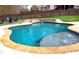 A sparkling in-ground pool with a stone border and waterfall feature at 37 Highcrest Dr, Acworth, GA 30101