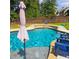 In-ground pool with a waterfall, lounge chairs, and an umbrella at 37 Highcrest Dr, Acworth, GA 30101