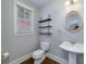 Charming powder room features a pedestal sink, decorative mirror, and modern fixtures at 37 Highcrest Dr, Acworth, GA 30101