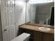 Bathroom with a sink, toilet, and a large vanity mirror at 5332 Shirewick Dr, Lithonia, GA 30058