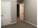 Bedroom with neutral walls, carpet, and double doors to a closet at 5332 Shirewick Dr, Lithonia, GA 30058