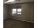 Simple bedroom with carpeted floor and large window at 5332 Shirewick Dr, Lithonia, GA 30058