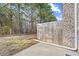 View of a private backyard featuring a concrete patio and a wooden privacy fence at 2056 Wildflower Way, Conyers, GA 30012