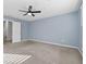 A bright bedroom with large windows, neutral carpet, a ceiling fan, and light blue walls at 2056 Wildflower Way, Conyers, GA 30012