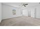 Large bedroom offers neutral carpet, walk-in closet, and natural light from large windows at 2056 Wildflower Way, Conyers, GA 30012