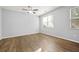 Bright bedroom featuring wood floors, ceiling fan, and large windows at 2056 Wildflower Way, Conyers, GA 30012
