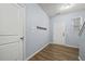 Inviting entryway features wood-look flooring, coat rack, and access to the staircase at 2056 Wildflower Way, Conyers, GA 30012