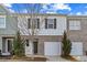Charming townhome with brick and siding exterior, garage, and well-manicured landscaping at 2056 Wildflower Way, Conyers, GA 30012