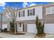 Charming townhome with brick and siding exterior, garage, and well-manicured landscaping at 2056 Wildflower Way, Conyers, GA 30012