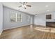 Bright living room featuring wood floors, ceiling fan, and a wet bar in the corner at 2056 Wildflower Way, Conyers, GA 30012