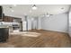 Open-concept living room featuring wood floors that connect to the kitchen and large windows at 2056 Wildflower Way, Conyers, GA 30012