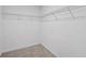 An empty walk-in closet featuring wire shelving and neutral carpet at 2056 Wildflower Way, Conyers, GA 30012