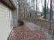 Image of a back deck covered with leaves, features gray railings and furniture at 3321 Border Dr, Stone Mountain, GA 30087