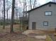 The back of home features gray siding, a raised deck, and a sloped, wooded lot at 3321 Border Dr, Stone Mountain, GA 30087