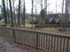 View of backyard from deck, with trees and other houses visible in the distance at 3321 Border Dr, Stone Mountain, GA 30087