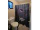 Bathroom featuring a toilet, shower with curtain, and small window at 3321 Border Dr, Stone Mountain, GA 30087