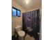 Bathroom featuring a toilet, shower with curtain, and small window at 3321 Border Dr, Stone Mountain, GA 30087