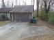 Image of the driveway, garage, and front exterior of a house with two trash cans at 3321 Border Dr, Stone Mountain, GA 30087