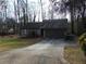 Exterior front view of a house showing the driveway, garage, and some landscaping at 3321 Border Dr, Stone Mountain, GA 30087
