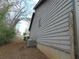 Side view of the house, showing the siding, a window, and the air conditioning unit on a sparse lawn at 3321 Border Dr, Stone Mountain, GA 30087