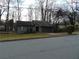 Single-level home with a gray exterior, stone detail, and bare trees in winter at 3321 Border Dr, Stone Mountain, GA 30087