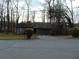 Single-story house with a gray exterior, bare trees, and an asphalt street at 3321 Border Dr, Stone Mountain, GA 30087