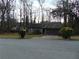 Modest home with a stone accent, bare trees, and an unmanicured lawn at 3321 Border Dr, Stone Mountain, GA 30087