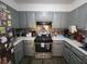 Charming kitchen featuring stainless steel appliances, gas range, and modern cabinetry at 3321 Border Dr, Stone Mountain, GA 30087