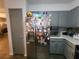 Well-lit kitchen featuring stainless steel refrigerator and gray cabinets at 3321 Border Dr, Stone Mountain, GA 30087