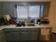 Kitchen featuring gray cabinets, updated countertops, and a modern stainless steel dishwasher at 3321 Border Dr, Stone Mountain, GA 30087
